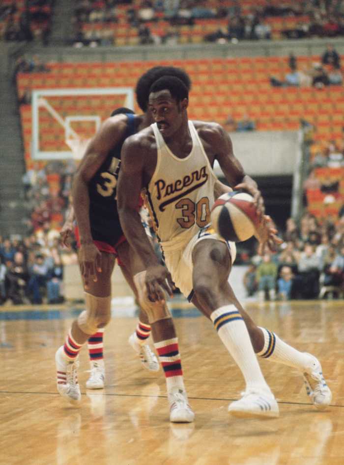 Indiana Pacers forward George McGinnis (30) against the New York Nets during an ABA game.